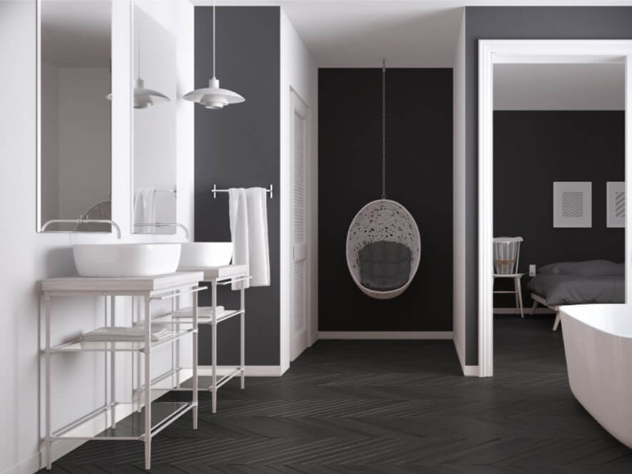 Modern Black and White Bathroom with Wooden Floors and White Sink and Bathtub and towels